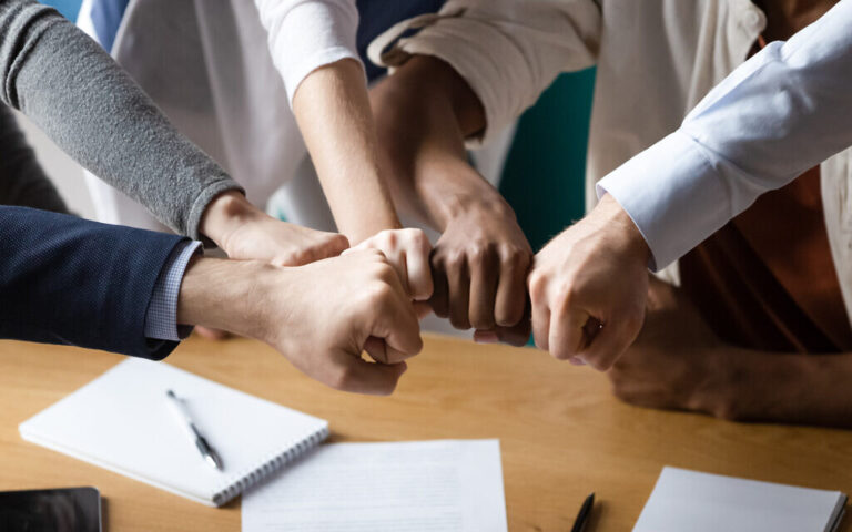 An illustrative image of solidarity at the workplace (fizkes; iStock at Getty Images)