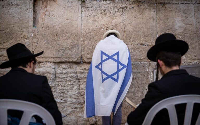 Jewish men pray at the Western Wall in Jerusalem Old City on the eve of Jerusalem Day, May 09, 2021. (Yonatan Sindel/Flash90)