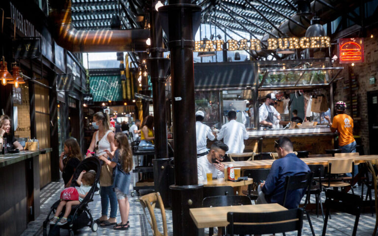 Customers enjoy dining at restaurants at the Sarona market  in Tel Aviv on April 21, 2021. (Miriam Alster/Flash90)