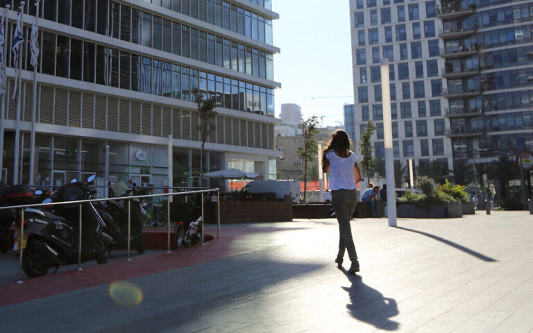 Illustrative: A woman walking toward a building at the Bnei Brak Business Center on October 23, 2017. Yaakov Naumi/FLASH90)