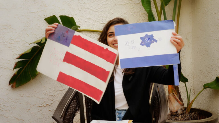Simone Zimmerman holds up elementary-school projects.