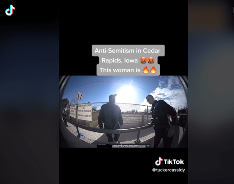 Police body camera footage of an incident involving men standing near antisemitic signs and a woman demanding they be taken down has gone viral on TikTok.