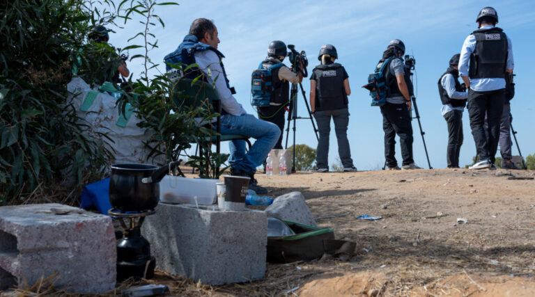 Members of the press wait on an overlook to report rocket attacks from Gaza, or Israeli bombardments, on October 21, 2023 in Sderot, Israel. (Alexi J. Rosenfeld/Getty Images)