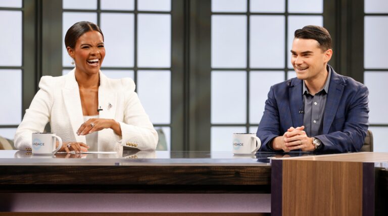 Two conservative pundits behind the desk of a talk show
