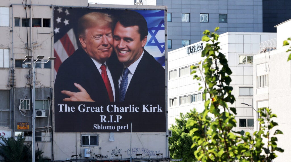 A billboard of Charlie Kirk hugging Donald Trump hanging in Israel