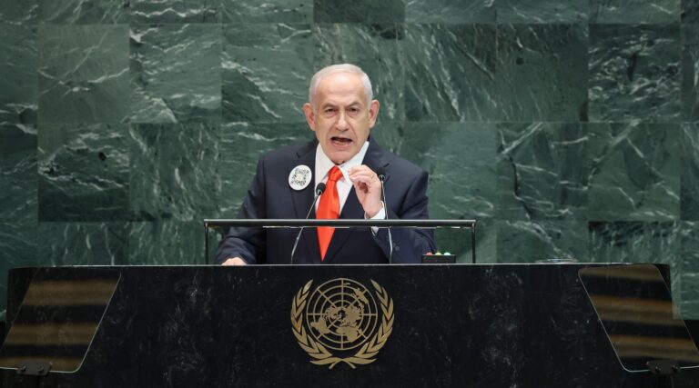 A photo of Netanyahu speaking from a podium.